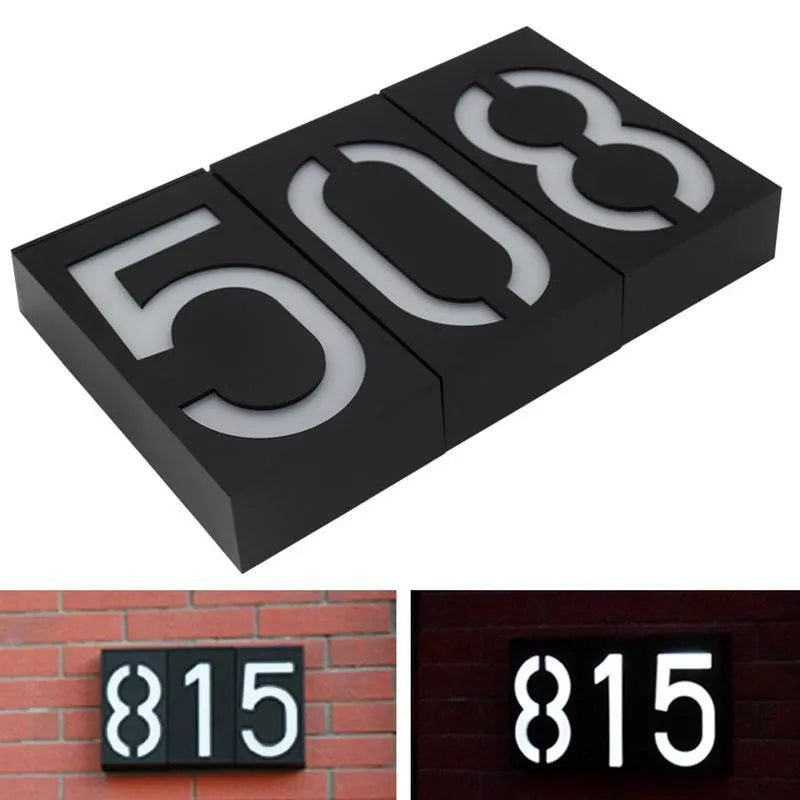 Solar-powered white LED house number light mounted on an outdoor wall