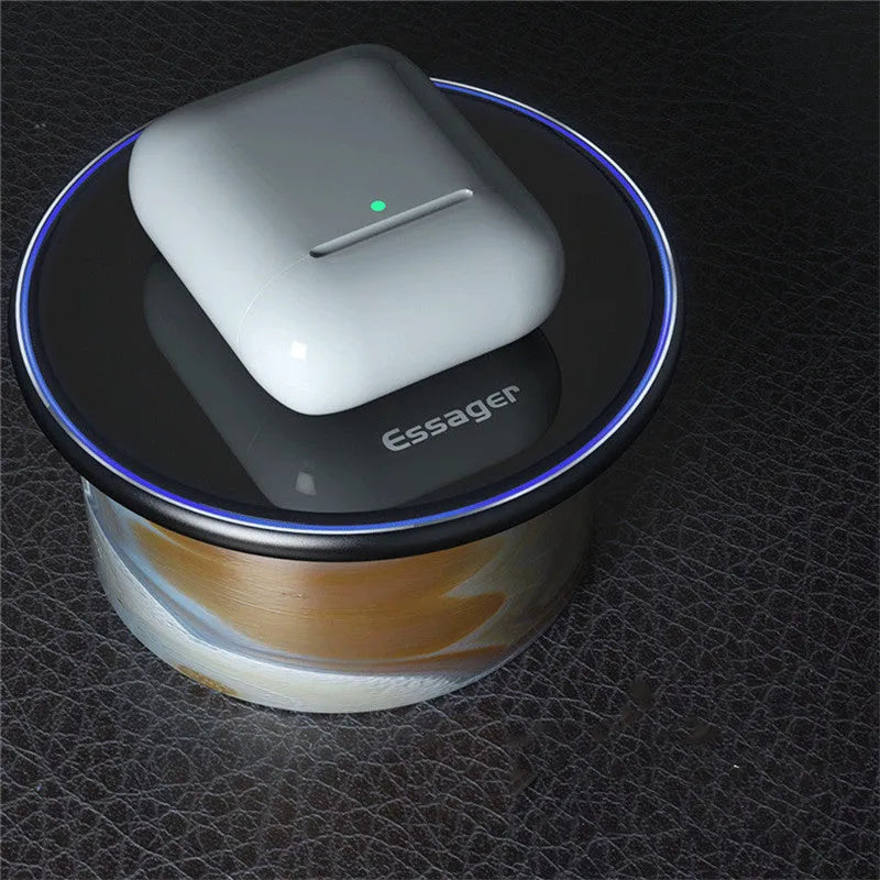 Black 15W fast wireless charging pad with LED indicator light on a desk