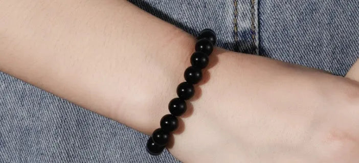 Geometric black agate stretch bracelet with 8mm beads on an elastic cord.