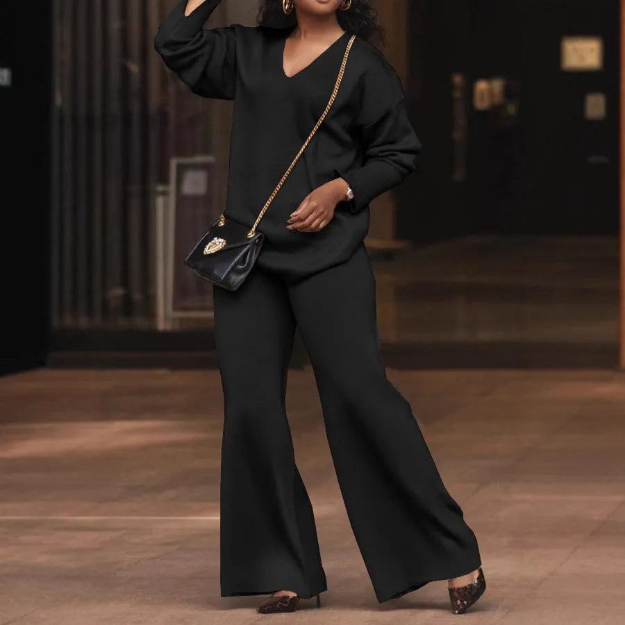 Women's brown suede two-piece suit with split sleeve detail on the long-sleeved top and matching trousers.