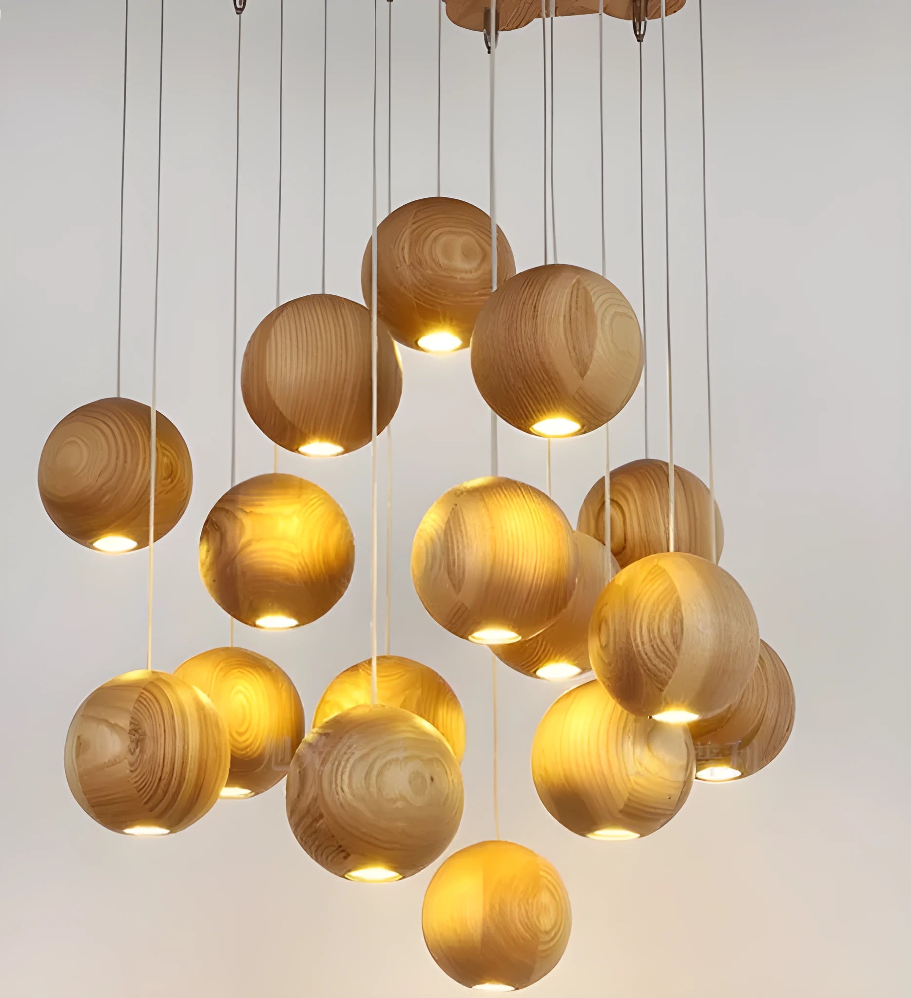 Nordic solid wood ball chandelier pendant light with wooden shade, shown in a living room setting.