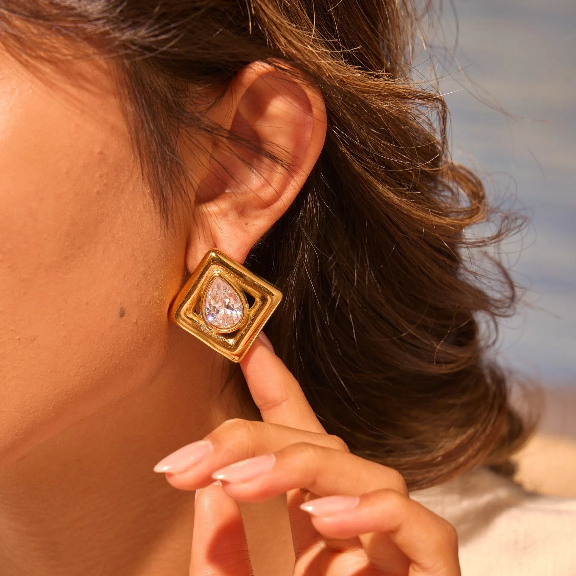 Gold stud earrings with geometric water drop zircon design on stainless steel