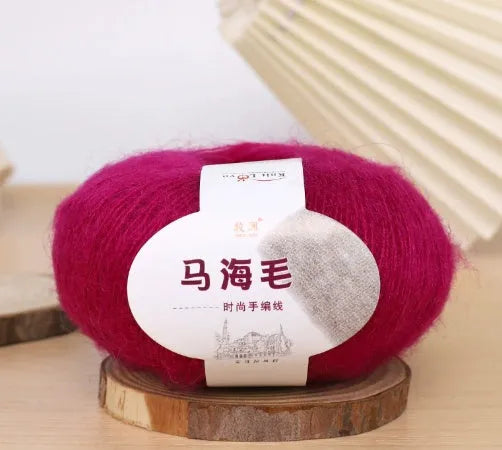 DIY mohair scarf weaving kit showing one wool ball and a selection of 34 colour options including white, pink, blue and green.