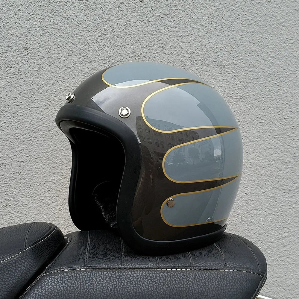 Glass fibre retro half motorcycle helmet shown in multiple colour options including cement grey and matte black flower patterns