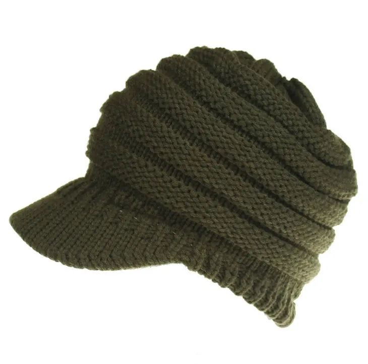 Women's acrylic knitted ponytail beanie hat in beige colour on a model.
