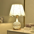 Gold crystal desk lamp with iron art base and remote control on wooden surface