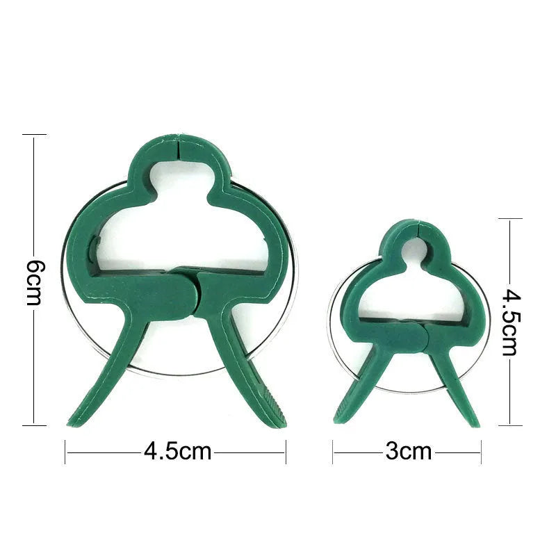 Green plastic and zinc plant fixing clips for large and small climbing plants like tomatoes and beans.