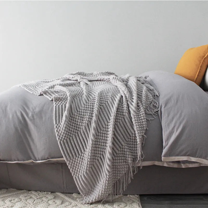 Small polyester fibre nap blanket measuring 127cm by 170cm in dark grey colour