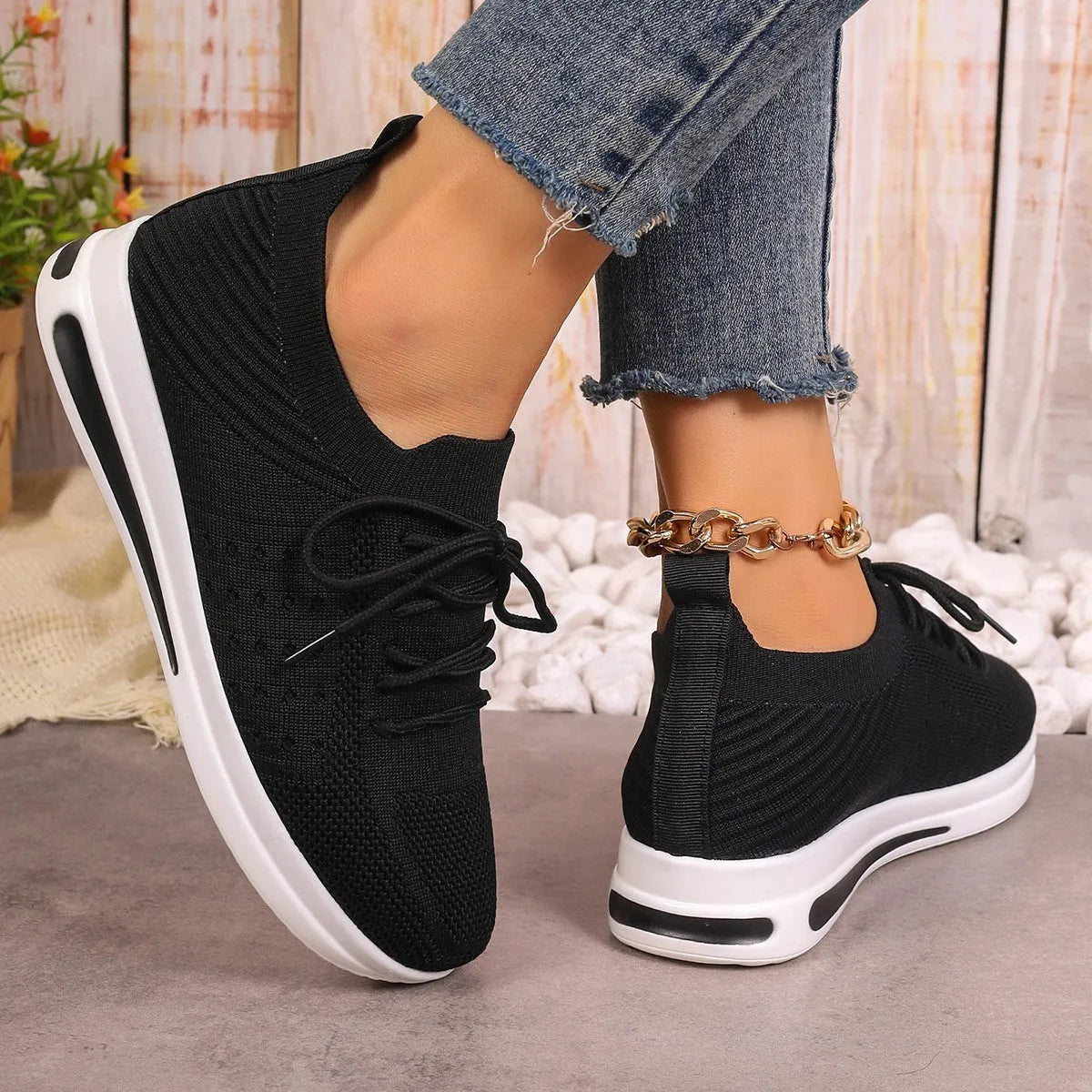 Women's low-top red fly-knit sneakers with round toe and lace-up front on a white background.