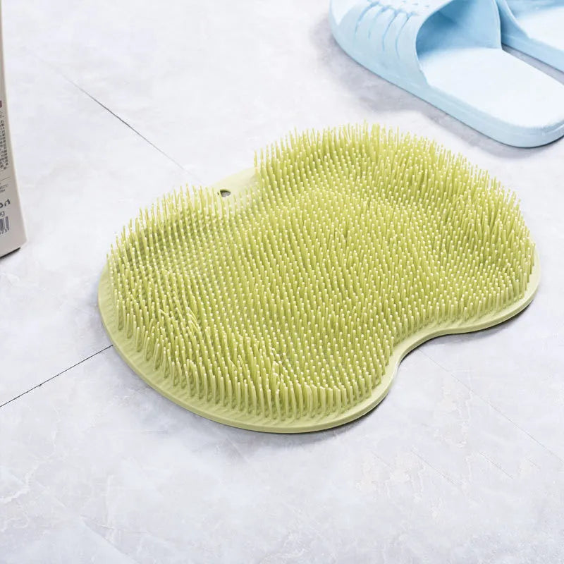 Orange silicone bristle bath brush with suction cups on base, size 23x30cm, for foot and back cleaning.