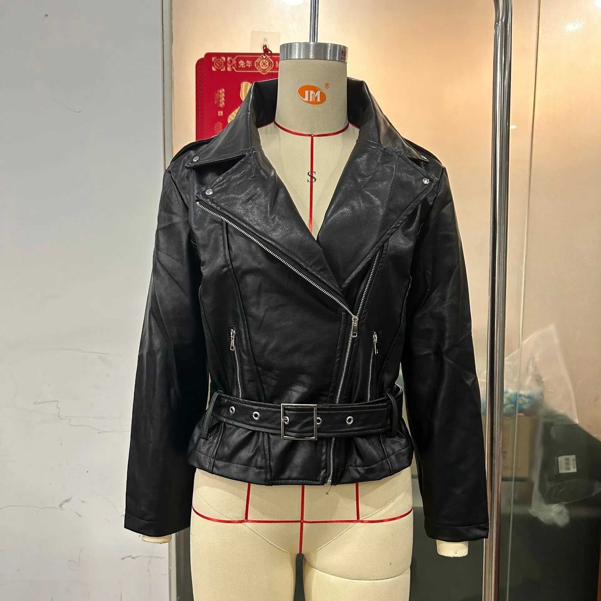 Black punk-style short jacket with a Peter Pan collar and a belt detail on the lapel.