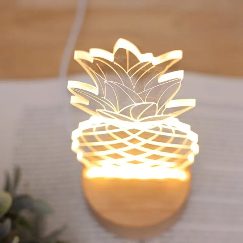 Cartoon pineapple-shaped USB night light with wood and acrylic casing on a table.