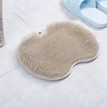Orange silicone bristle bath brush with suction cups on base, size 23x30cm, for foot and back cleaning.