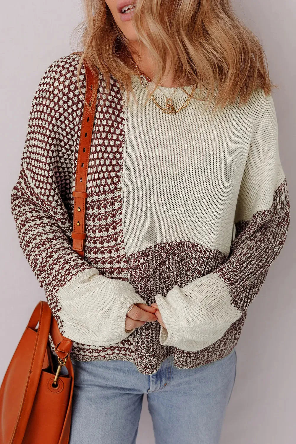 Dark khaki colour block loose sweater with back tie and drop shoulders on a hanger.