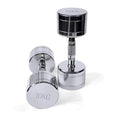 Silver pure steel dumbbell with hexagonal grip on a grey background.