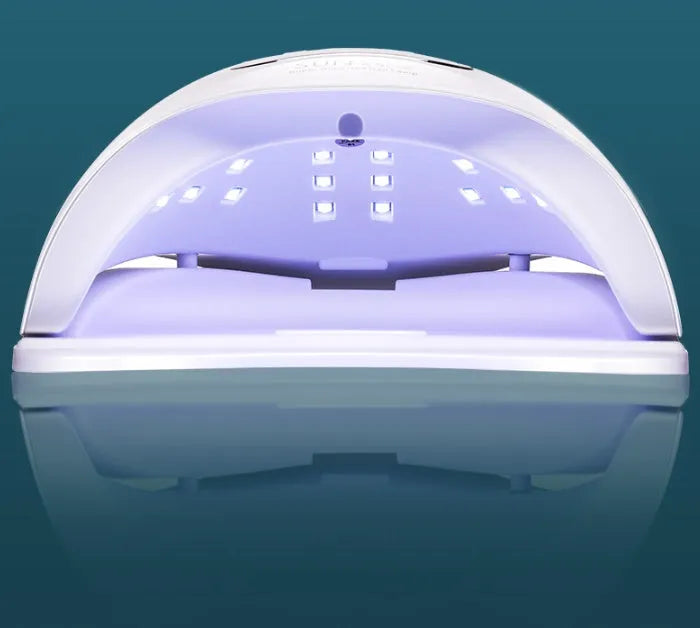 White nail polish curing lamp with UV and LED light sources for gel manicures