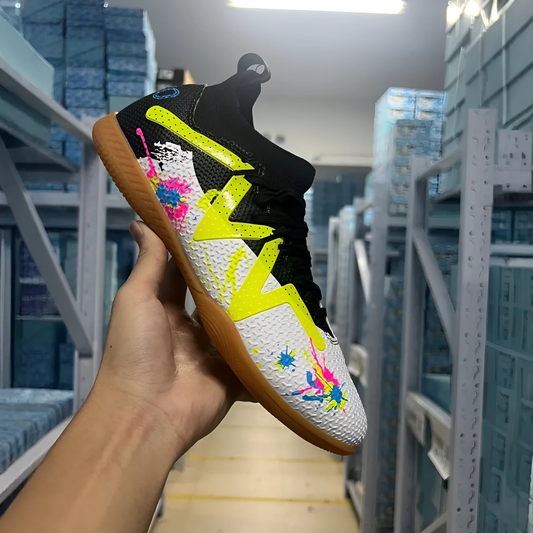 Low-top football shoes with studded rubber outsoles in black and yellow colour combination