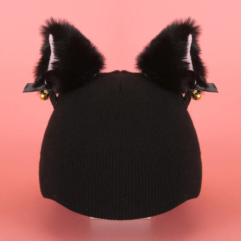 Plush fabric ski helmet decoration with cartoon design on a black ski helmet.
