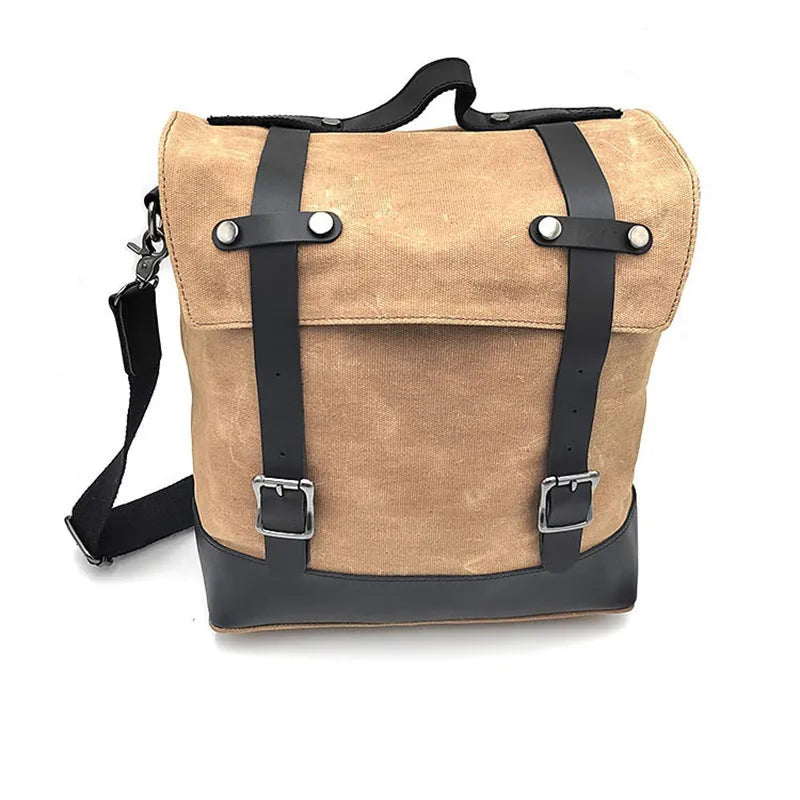 Black waterproof canvas motorcycle side pannier bag with cowhide accents showing mounting straps