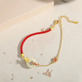 Koi peace buckle hetian jade red rope bracelet in 925 silver with gold electroplated finish