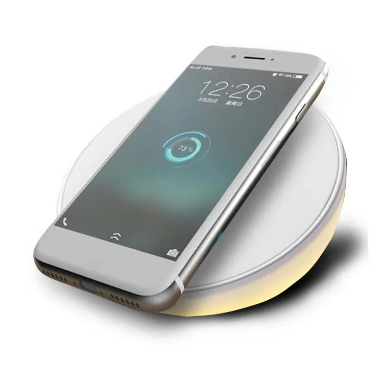 White wireless phone charger with digital clock display showing time, measuring 115mm long