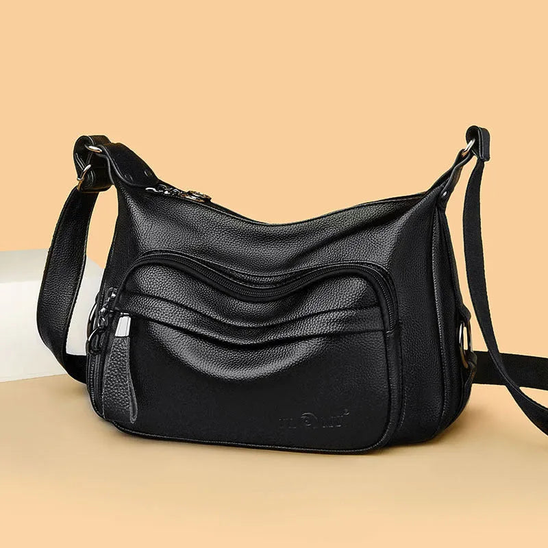 Blue women's large crossbody shoulder bag with multiple internal compartments and soft horizontal square design