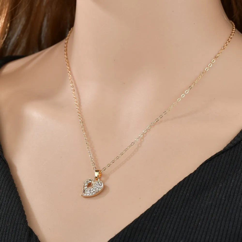 Gold-colour women's jewellery set with earrings, adjustable necklace and bracelet featuring heart, water drop and bell charms.