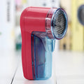 Portable electric lint remover for clothing on a white background