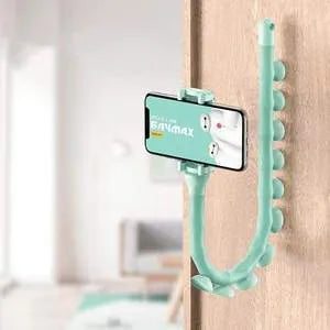 Flexible rubber phone holder with suction cup mounted on desktop showing 360-degree rotation