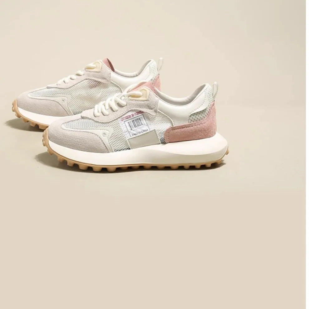 Women's grey and pink retro sneakers with mesh lining, rubber sole, and round toe design