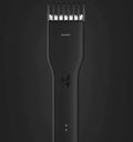 Black cordless hair clipper with ceramic blades and adjustable length comb