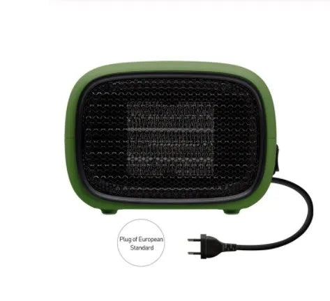 Compact green portable ceramic fan heater with metal grille, shown on a desk