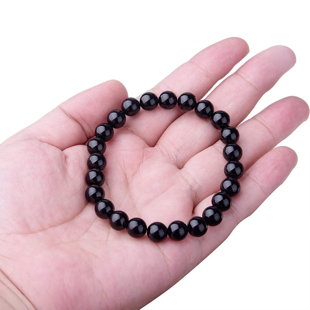 Geometric black agate stretch bracelet with 8mm beads on an elastic cord.
