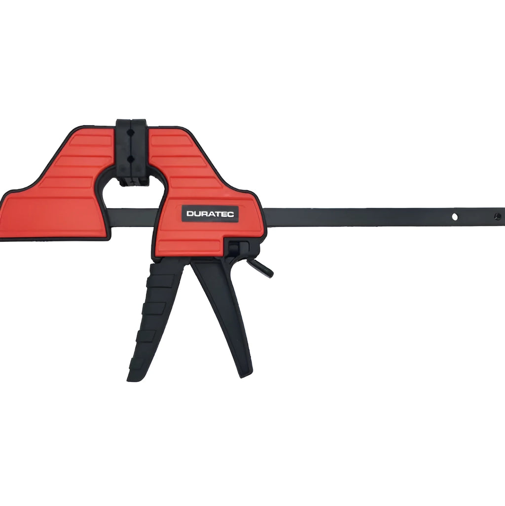 Black plastic woodworking clamp with quick-adjust key and soft rubber protective jaws.