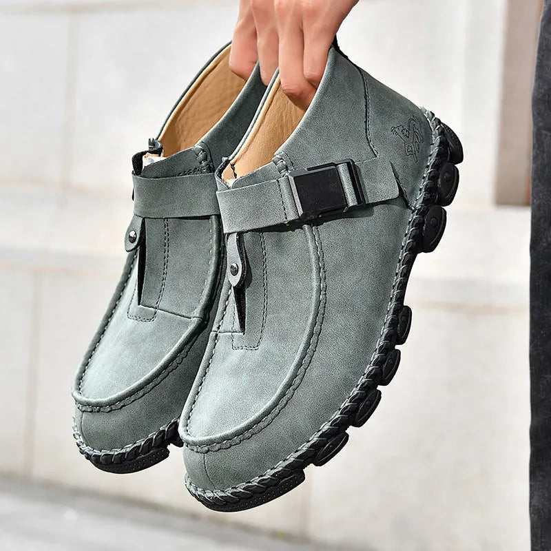 Handmade stitched casual slip-on shoes in black, flat sole with low heel.