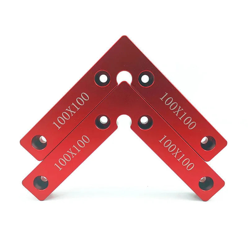 Aluminum alloy woodworking right angle positioning block on a workbench.
