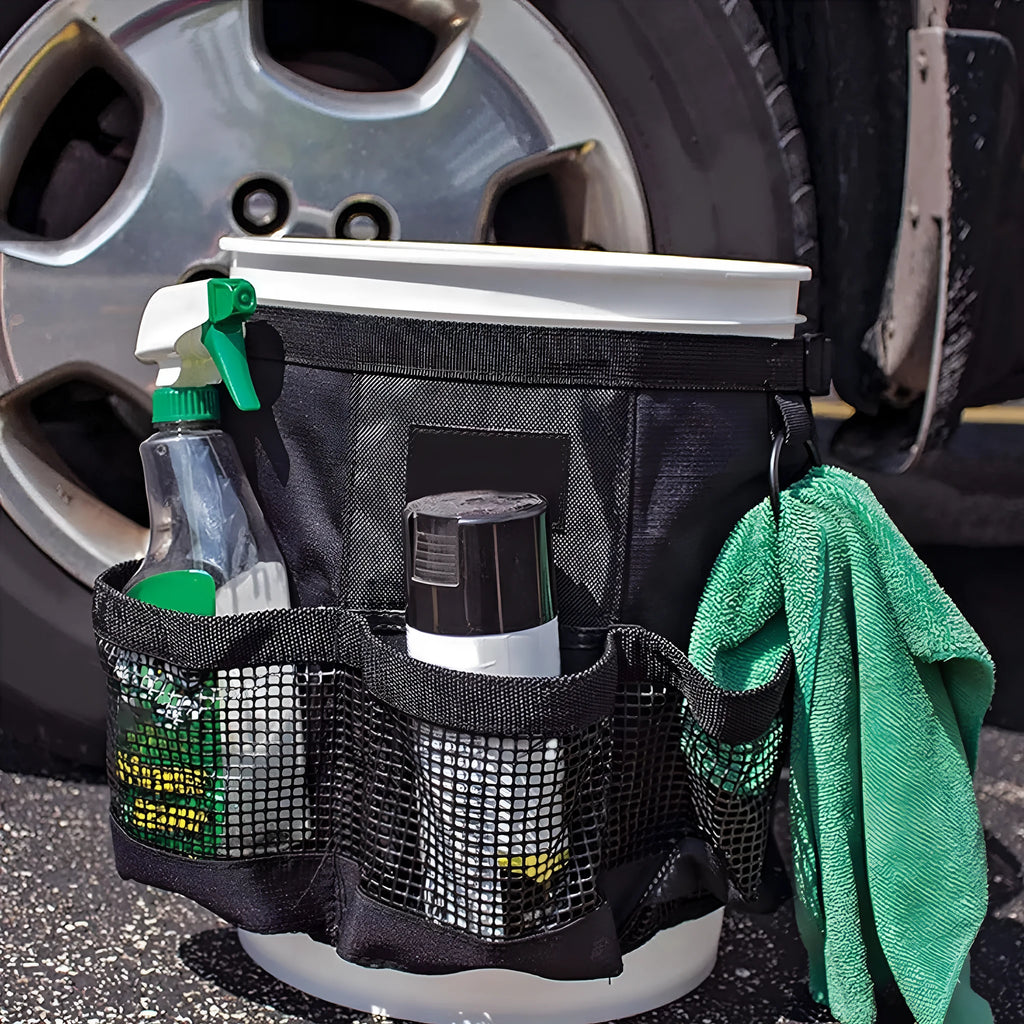 Black cylindrical polyester storage bag hanging on a 5 gallon barrel for car washing tools and outdoor gear.