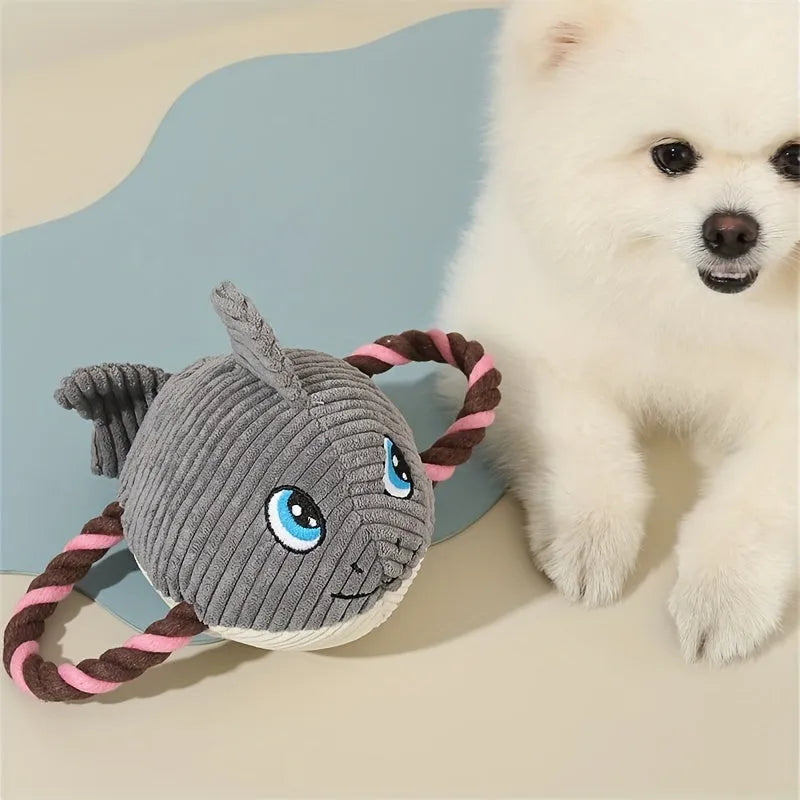 Green turtle-shaped plush dog chew toy with a knotted rope visible inside, on a white background.