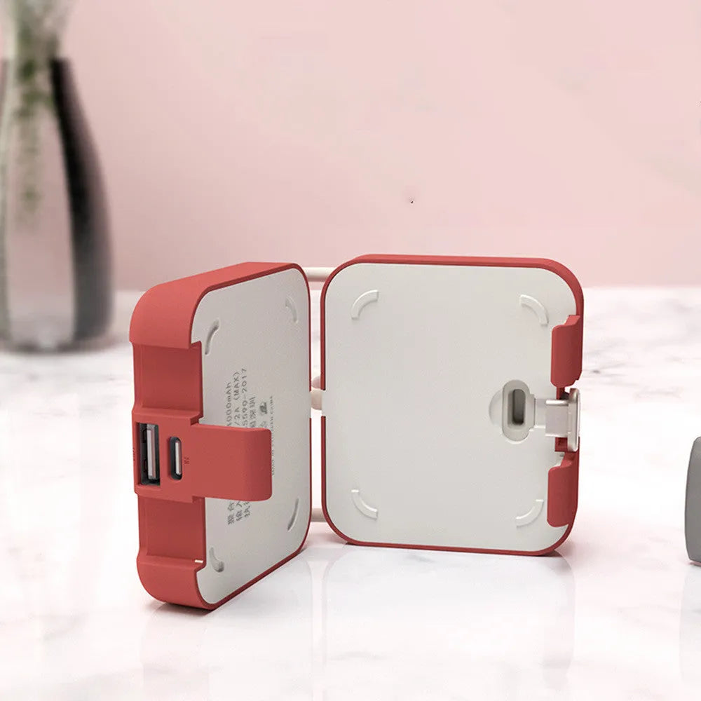 Handbag clip power bank in blue showing phone stand function with charging ports visible