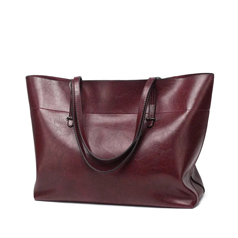 Cowhide leather cross-body handbag showing internal compartments and mobile phone pocket