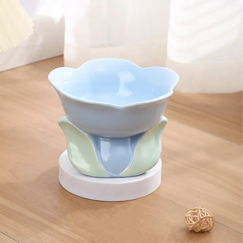 Blue ceramic elevated pet bowl with floral pattern and non-slip base for cats or small dogs.