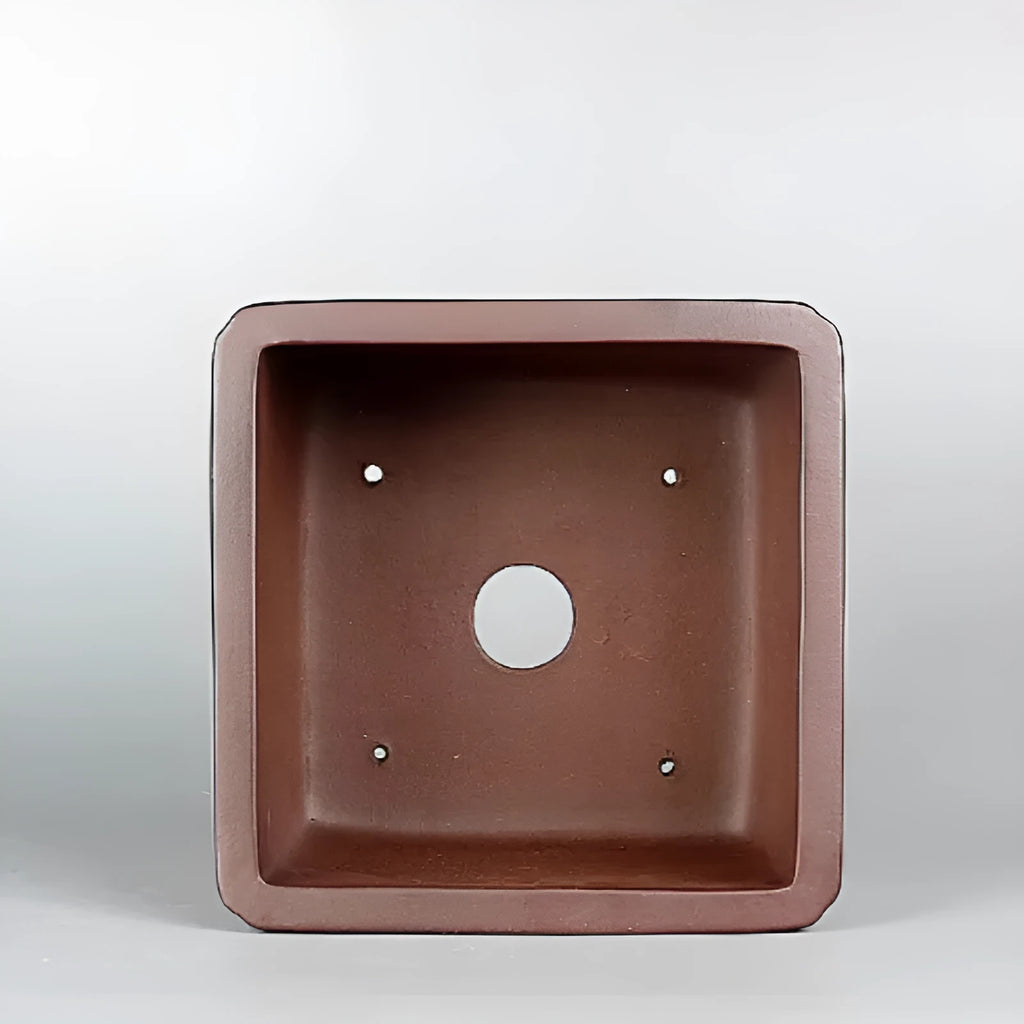 Brown handmade purple clay flower pot measuring 19cm wide with single drainage hole