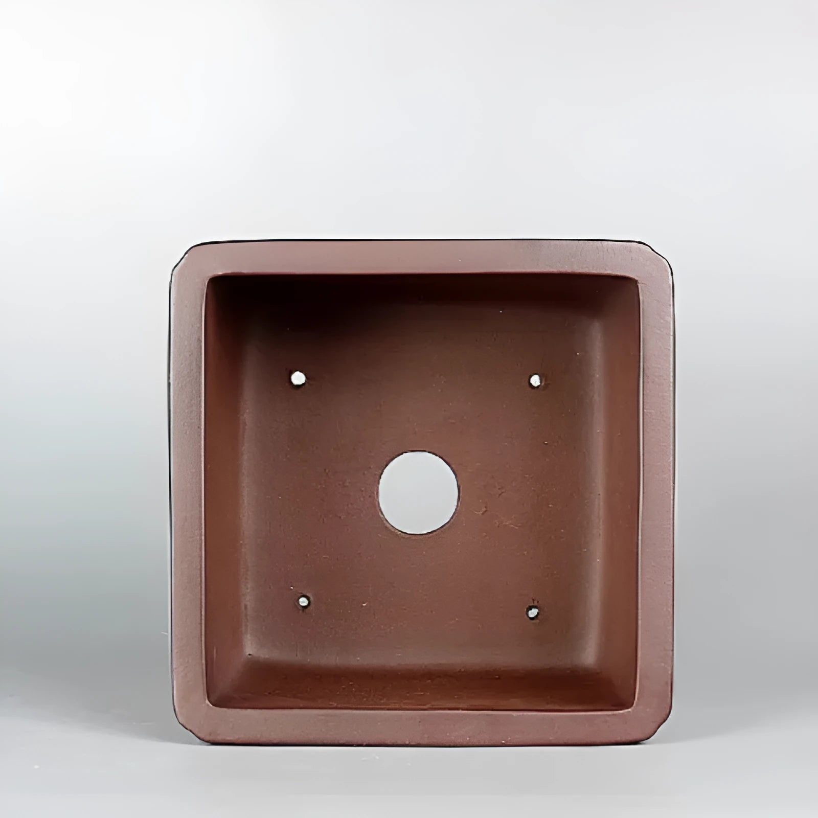 Brown handmade purple clay flower pot measuring 19cm wide with single drainage hole