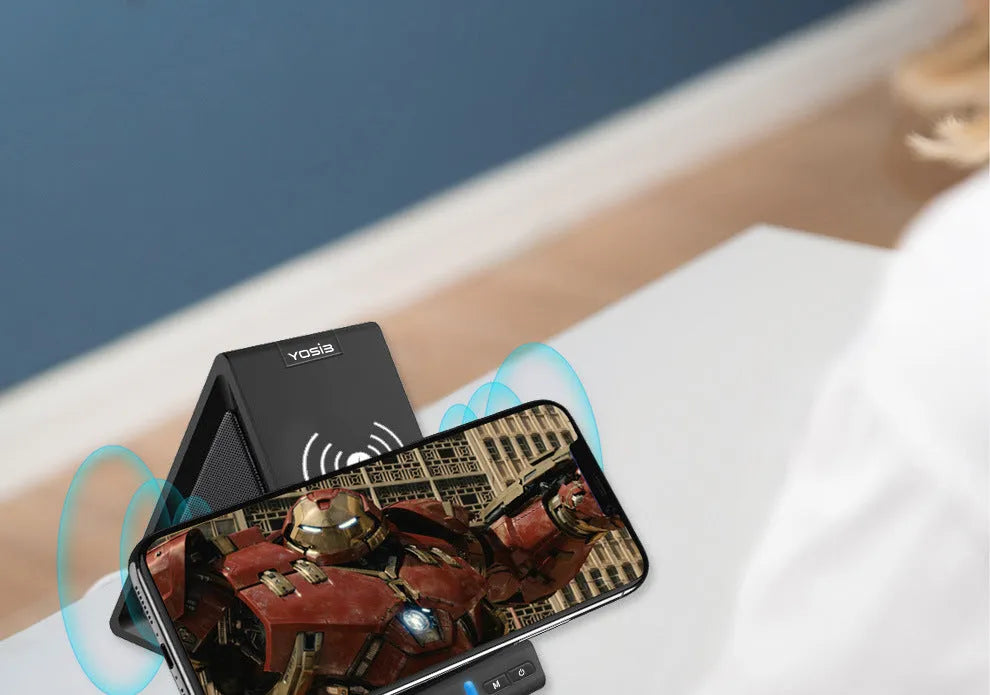 Black multifunctional Bluetooth speaker with integrated mobile phone stand and wireless charging area