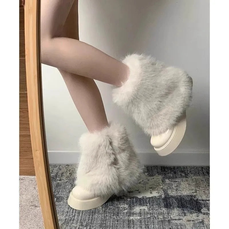 Women's black artificial plush snow boots with a round toe, low-top design, and a mid rubber sole.