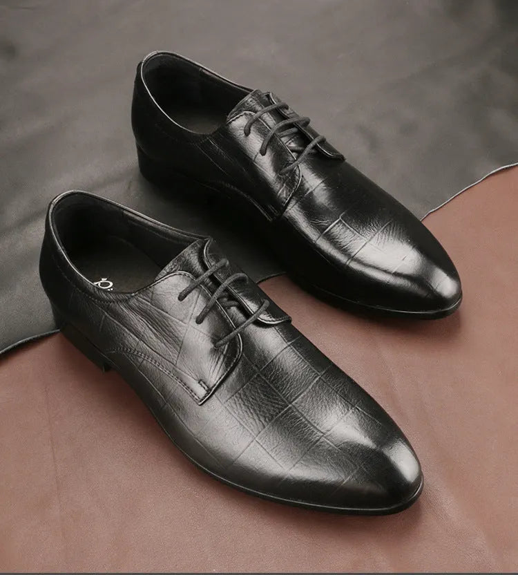 Men's black leather derby shoes with pointed toe and checkered pattern on a white background.