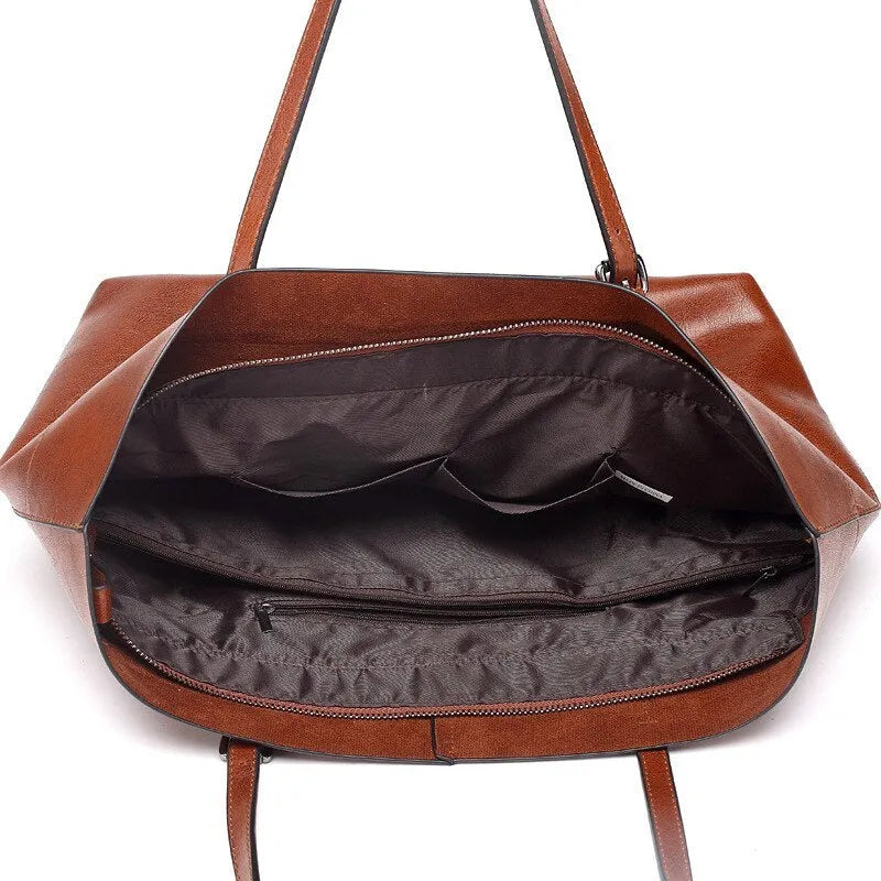 Cowhide leather cross-body handbag showing internal compartments and mobile phone pocket