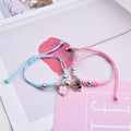 Pair of magnet couple bracelets with suction clasp on wrist, showing alloy designs like crown and love lock.