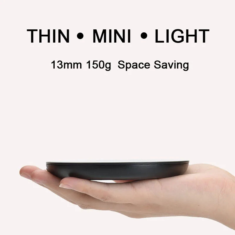 Black coffee mug warmer on a desk with low and high temperature switch