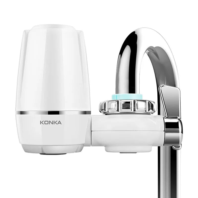 White plastic faucet-mounted water filter with ceramic cartridge and tap adapters